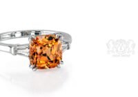 Leon Megé bespoke three-stone ring with a Mandarin garnet and a pair of tapered baguettes r7199