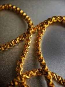 gold chain necklace on gray textile, Why Is Gold So Cheap In Thailand?