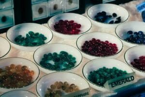 a table full of bowls of gemstones. are black star sapphire valuable?