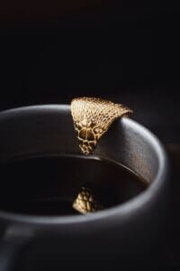 a close up of a gold ring on a black surface